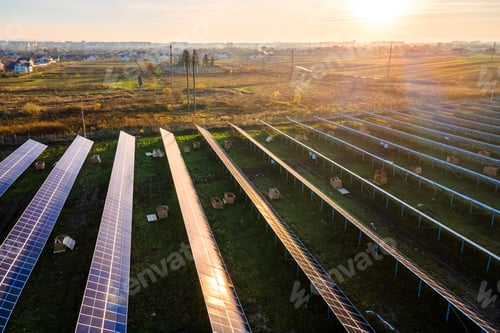 Preview: Aerial view of solar power plant under construction on green field. Assembling of electric panels