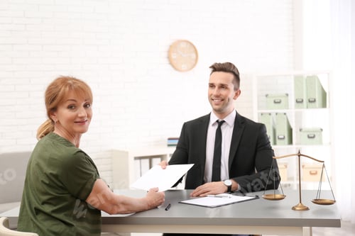 Preview: Young lawyer having meeting with senior client in office