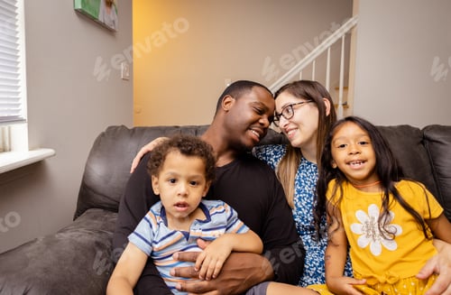 Preview: Happy diverse family at home bonding together