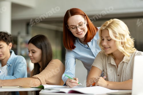 Preview: Teacher or tutor having lesson, learning language with school children in classroom. Education