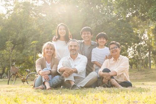 Preview: Group of diversity people sitting on grass at a park