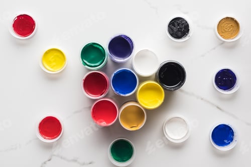 Preview: top view of multicolored gouache paints on marble white surface