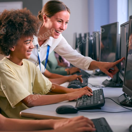 Preview: Group Of Secondary Or High School Students At Computers In IT Class With Female Teacher