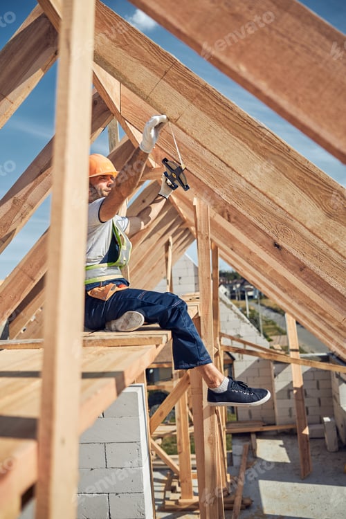 Preview: Competent builder using tape measure on his site