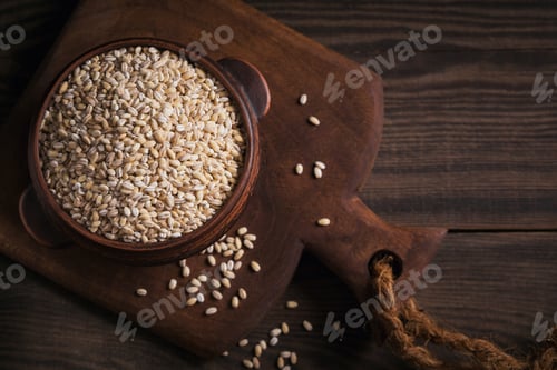 Preview: Organic uncooked dried barley cereal grain in a bowl