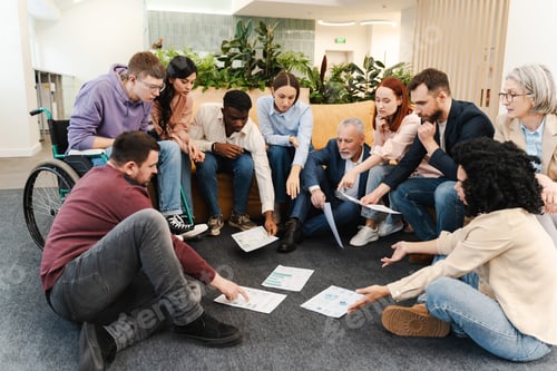 Preview: Group of diverse, multiracial people working together in modern office. Businesspeople discussing