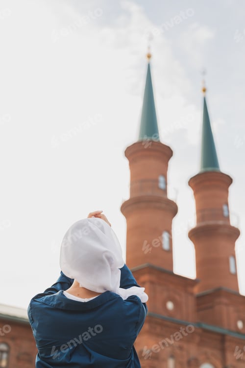 Preview: Muslim woman prayer wear hijab fasting pray to allah on mosque background