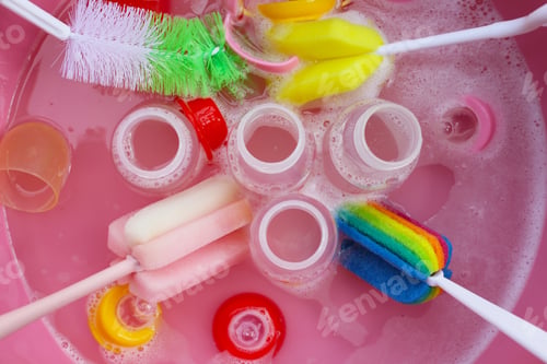 Preview: Wash baby bottles in plastic pink basin