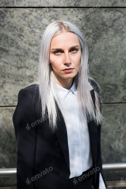 Preview: Portrait of serious young businesswoman outdoors