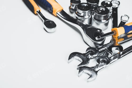 Preview: Collection of various hand tools including wrenches and ratchets on a clean surface