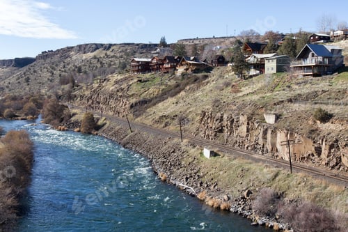 Preview: View on the residential homes by the river during a vibrant sunny winter day