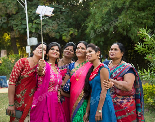 Preview: Indian happy women group is taking selfie on smart phone,