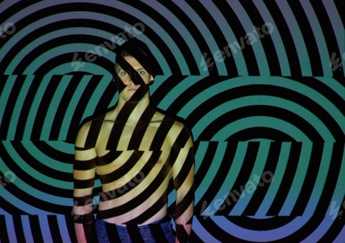 Preview: What you see isnt always whats real. Studio shot of a young man posing against abstract lighting.