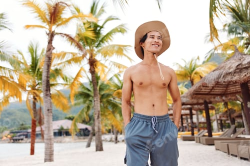 Preview: Muscular Asian Man Enjoying Summer Vacation on Tropical Island Beach
