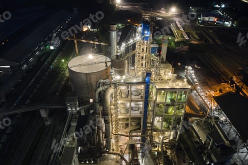 Preview: Aerial view of cement factory with high concrete plant structure and tower cranes