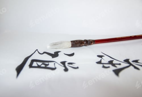 Preview: Writing on a white surface and a brush