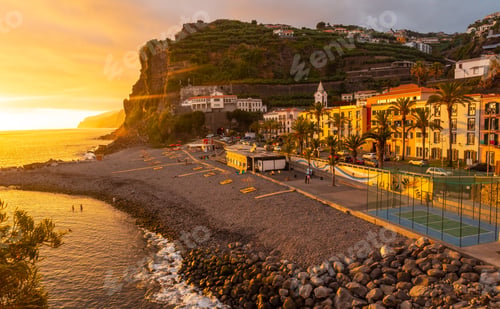 Preview: Sunset in Ponta do Sol, Madeira, aerial view of the beach in summer with the sun setting. Portugal