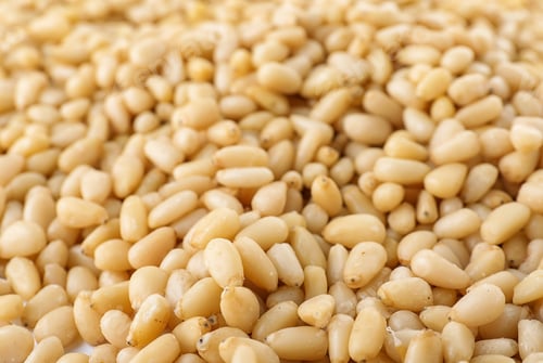 Preview: Pile of pine nuts as background, closeup