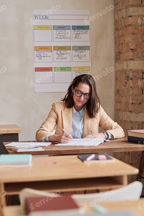 Preview: Teacher at Desk in Classroom