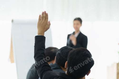 Preview: business person showing hand up for presentation in meeting room seminar training.