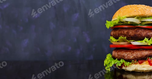 Preview: Delicious handmade burger on dark background. Banner.