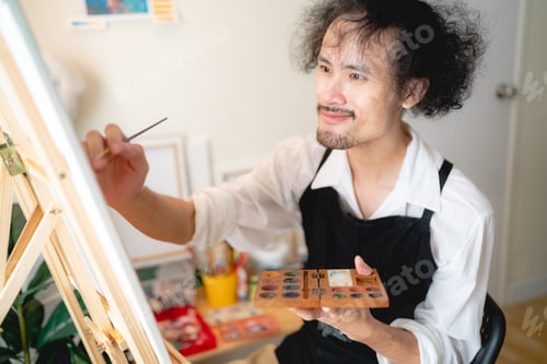 Preview: creative artist working watercolor art drawing picture with brush paint in hobby