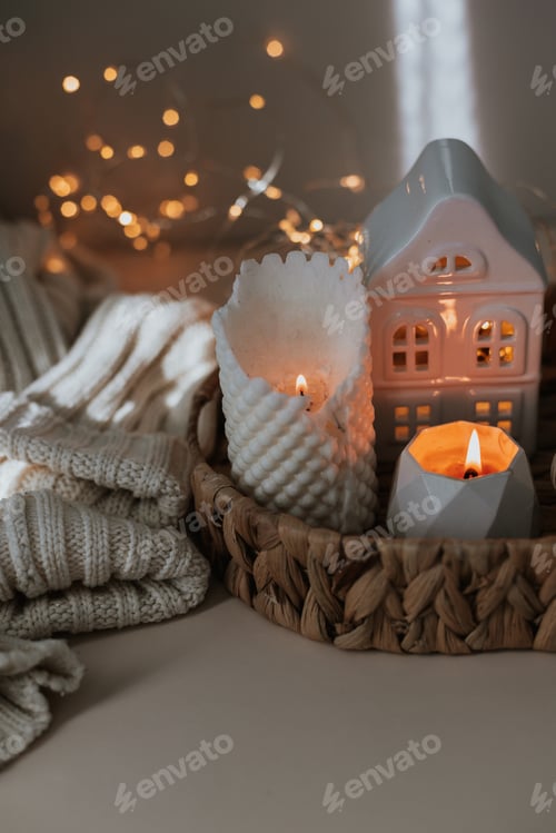 Preview: Cozy burning candles and winter home interior decor. Winter cozy style. Hygge concept.