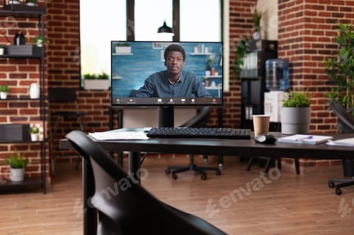 Preview: Monitor with video call conference at business office desk