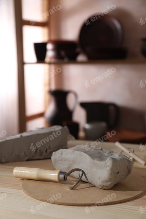 Preview: Clay and modeling tool on wooden table in workshop