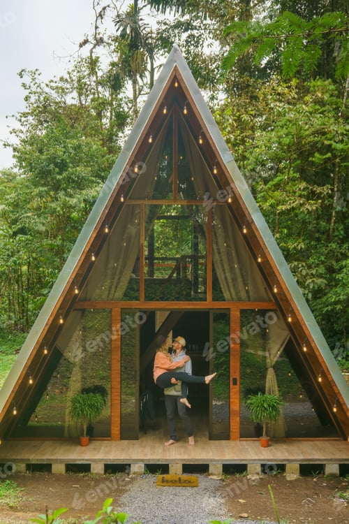 Preview: Couple near the A-frame house in the evening