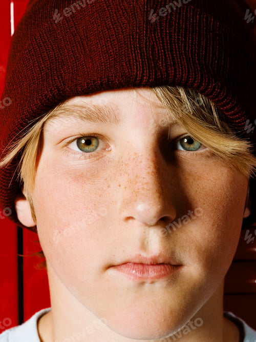 Preview: Boy wearing knit hat in school locker room, portrait