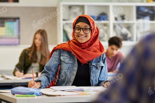 Preview: Portrait of smiling muslim teen student at school