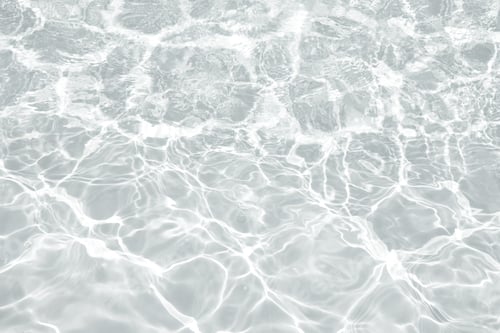 Preview: Abstract water background with ripples. Light caustics effect.