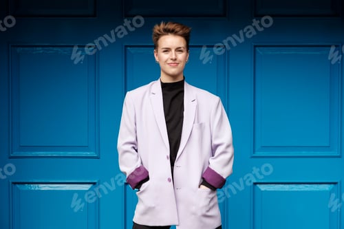 Preview: Natural portrait of alternative female model in front of blue door.