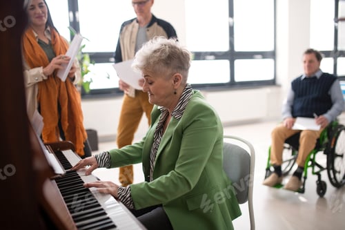 Preview: Senior woman playing at piano in choir rehearsal.
