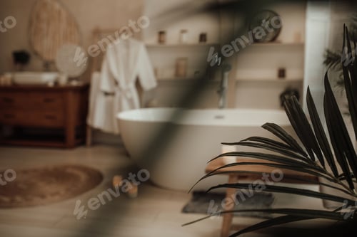 Preview: Luxury interior of big bathroom at modern african style with oval bathtub in natural lighting