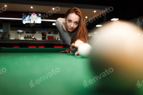 Preview: Concentrated girl while playing billiards