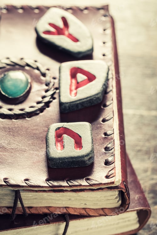 Preview: Leather book and black rune stones using futhark alphabet