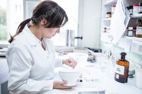 Preview: Woman preparing medicine in laboratory of a pharmacy
