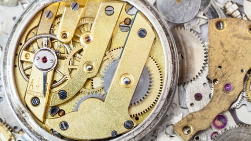 Preview: brass mechanical watch on heap of spare parts