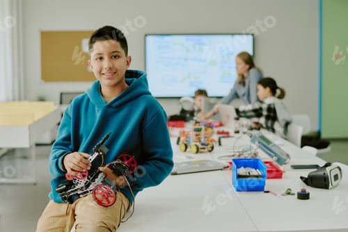 Vista previa: Smiling Boy with Robot Sitting on Desk