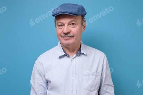 Preview: Portrait of a smiling and confident senior good looking business man with hat