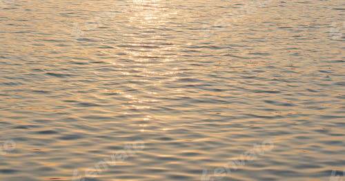 Preview: Water surface with a beautiful bokeh of sun glares