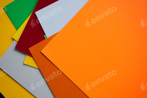 Preview: Multicolored paper with orange paper top view. flat lay or top view with copy space.