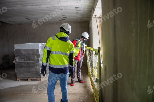Preview: The architect of the building project and the construction manager walking inside the new building