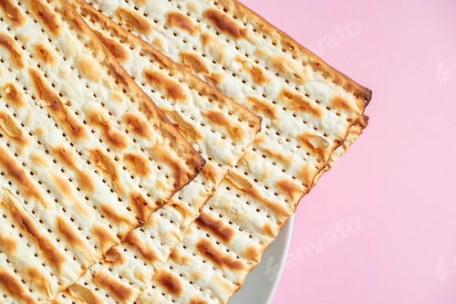 Preview: Happy Passover. Matzo on a pink background.