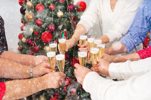 Preview: New Year or Christmas celebration. Hands holding the glasses of champagne.