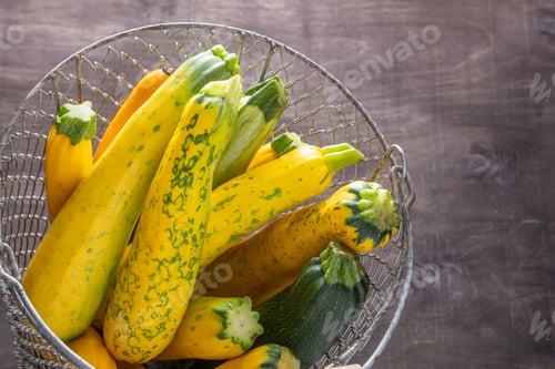 Preview: Yellow-green leopard-spotted zucchini. Vegetables on the table. Zucchini harvest.