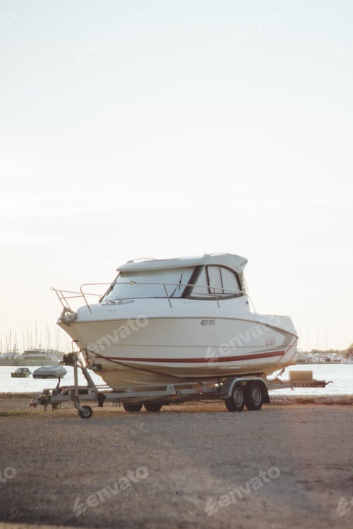 Preview: Vertical shot of the white motorboat on the trailer.