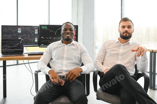 Preview: Two successful trader sitting in office, checking cryptocurrency information data